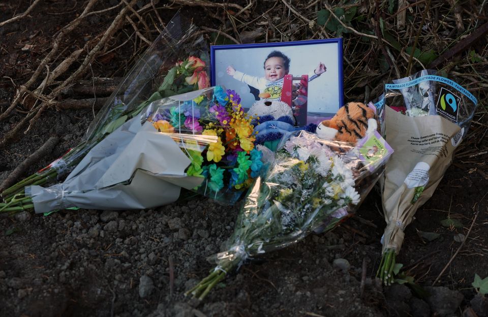 Floral tributes and a picture of Daniel Aruebose near the spot where remains were discovered. Photo: Collins